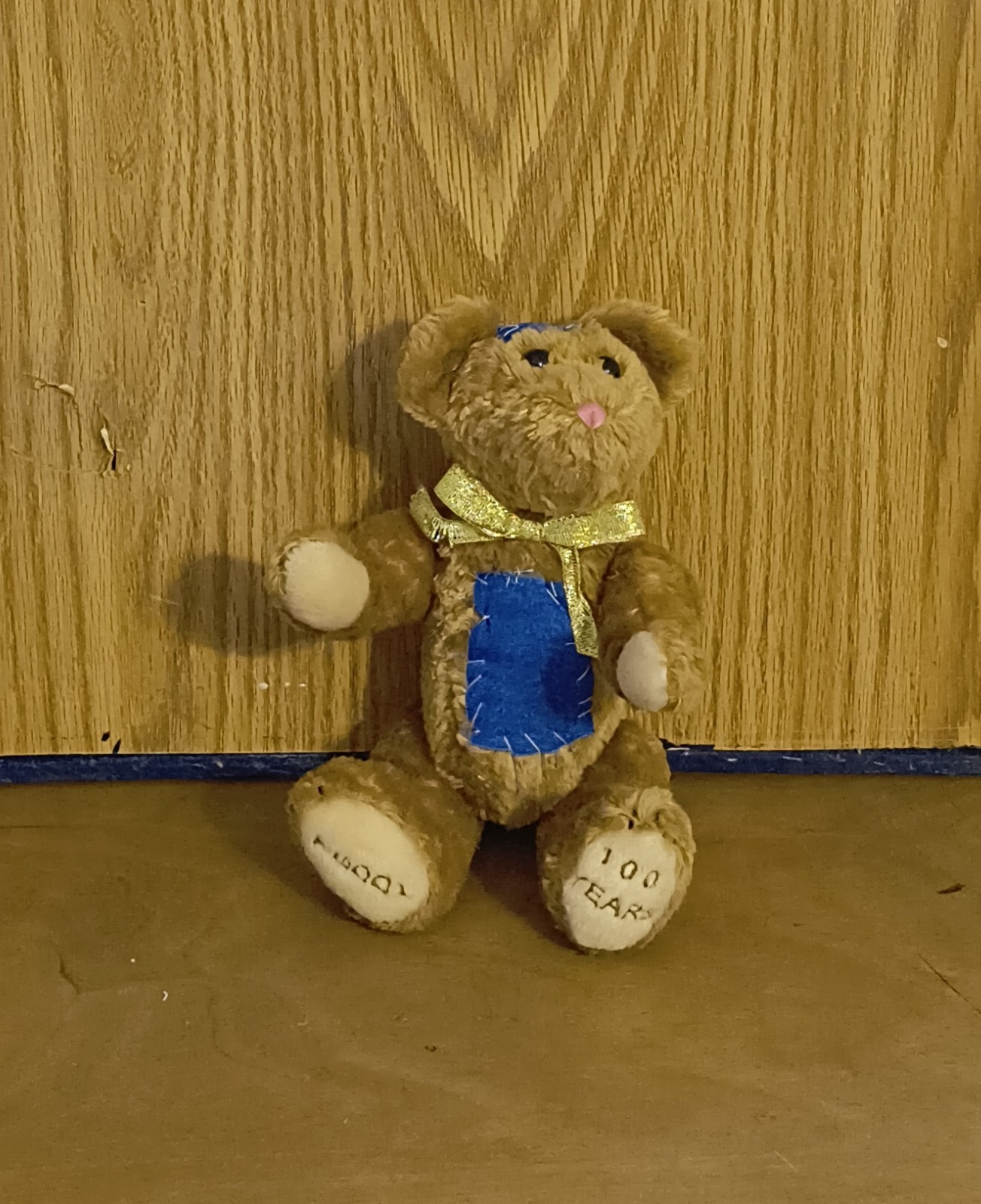 Patches Teddy Bear with blue belly patch and gold ribbon